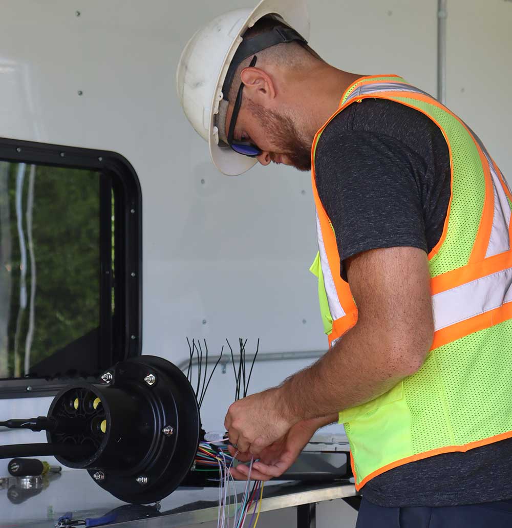 National OnDemand fiber technician splicing 144-count fiber for an infrastructure project near North Zulch, Texas
